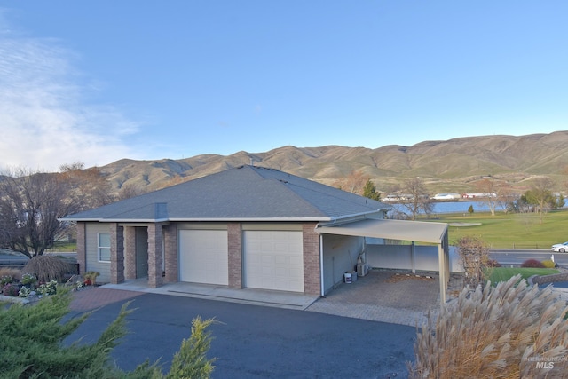 view of front of property featuring a mountain view and a garage