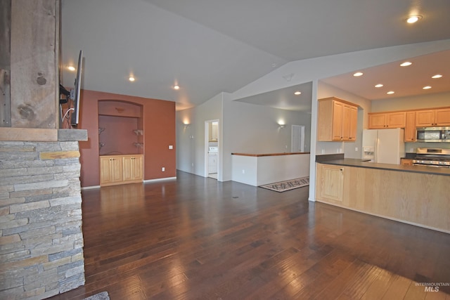 kitchen featuring light brown cabinets, dark hardwood / wood-style flooring, stainless steel appliances, and vaulted ceiling