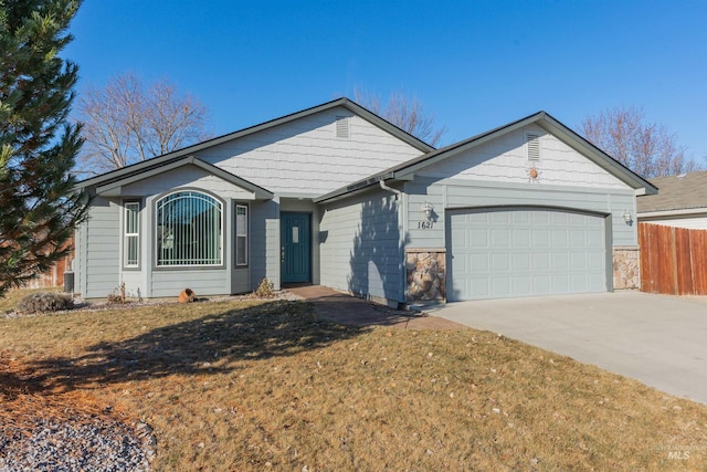 ranch-style house with a garage and a front yard