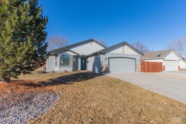 single story home featuring a garage and a front yard