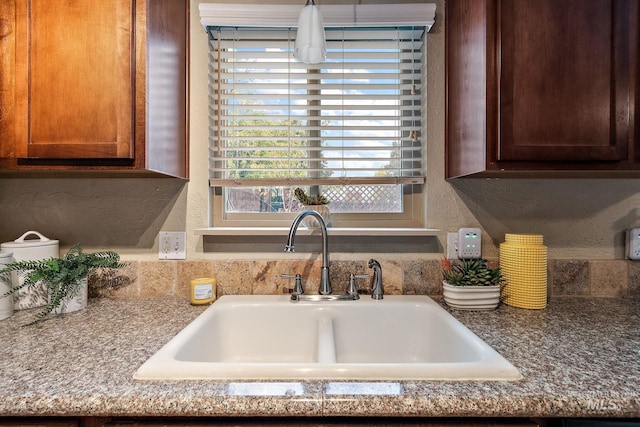 kitchen with sink and stone countertops