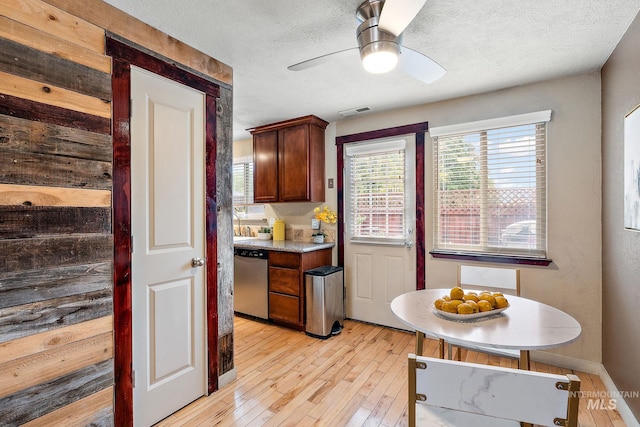 kitchen with dishwasher, a textured ceiling, light wood-type flooring, and ceiling fan