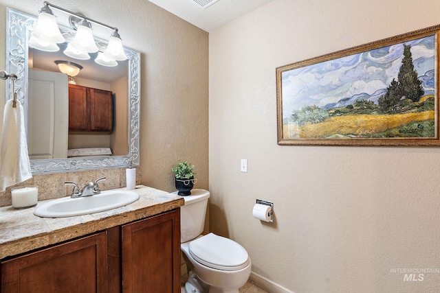 bathroom with toilet and vanity