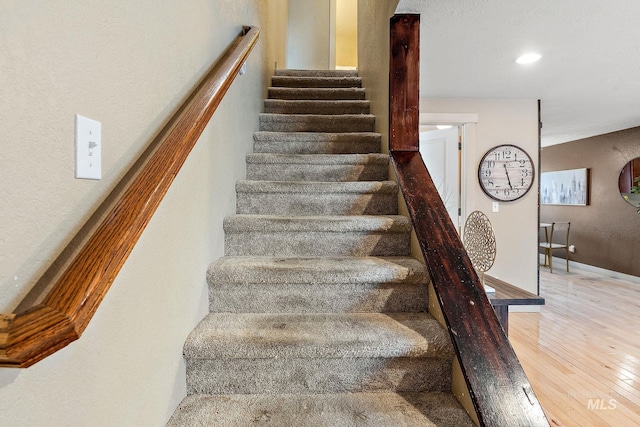 stairway with hardwood / wood-style floors