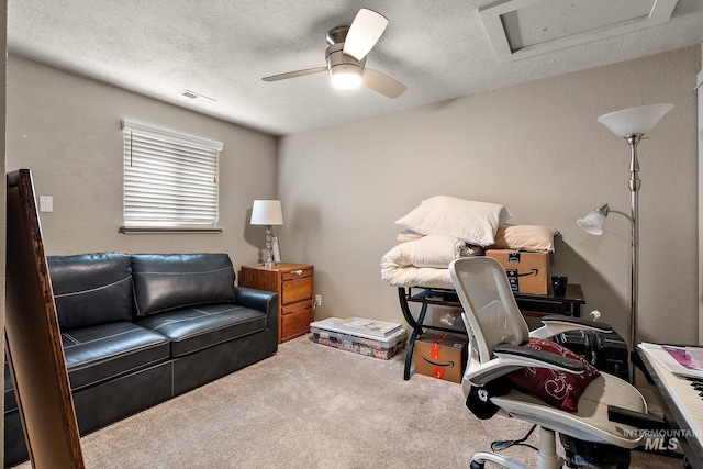 office area featuring carpet floors, a textured ceiling, and ceiling fan