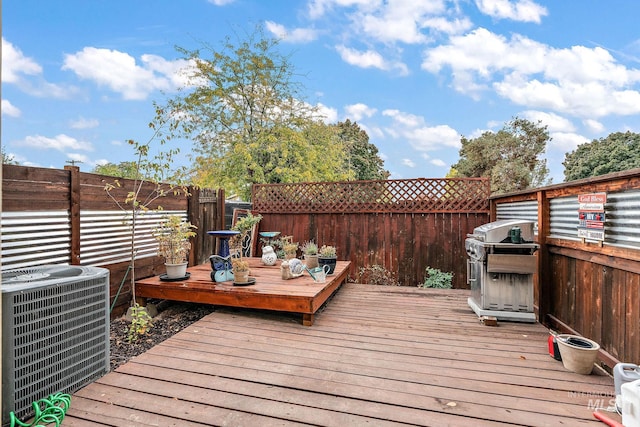 wooden deck featuring central AC unit