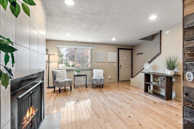 living area featuring a textured ceiling and light wood-type flooring