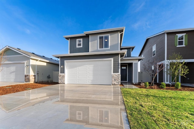 690 N Tessa Ave, Meridian, ID 83642 - view of front of home featuring stone siding, driveway, a front lawn, and a garage