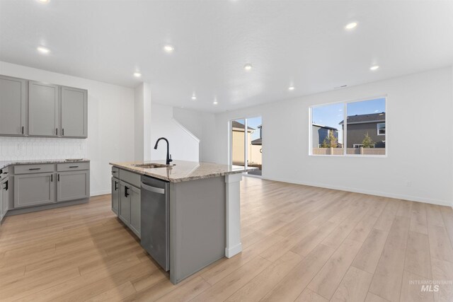 690 N Tessa Ave, Meridian, ID 83642 - kitchen with a sink, gray cabinets, dishwasher, light wood-style flooring, and light stone countertops