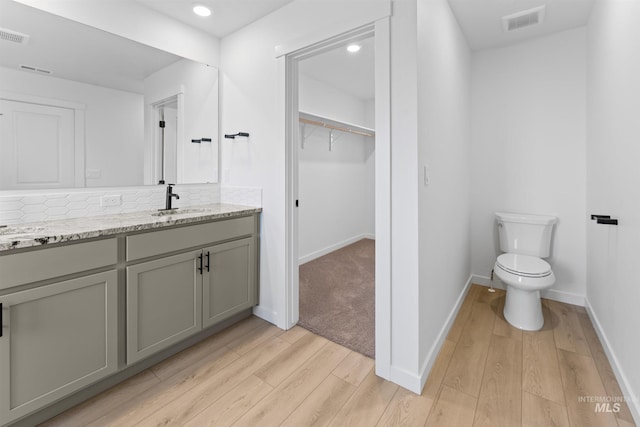 690 N Tessa Ave, Meridian, ID 83642 - bathroom featuring wood finished floors, vanity, baseboards, decorative backsplash, and recessed lighting