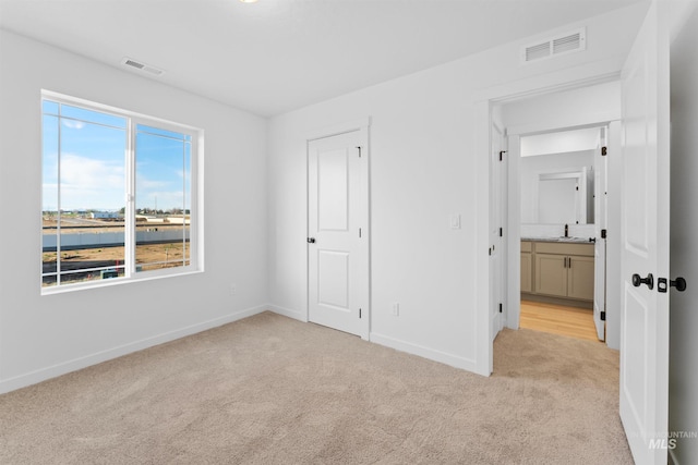 690 N Tessa Ave, Meridian, ID 83642 - unfurnished bedroom with light carpet and baseboards