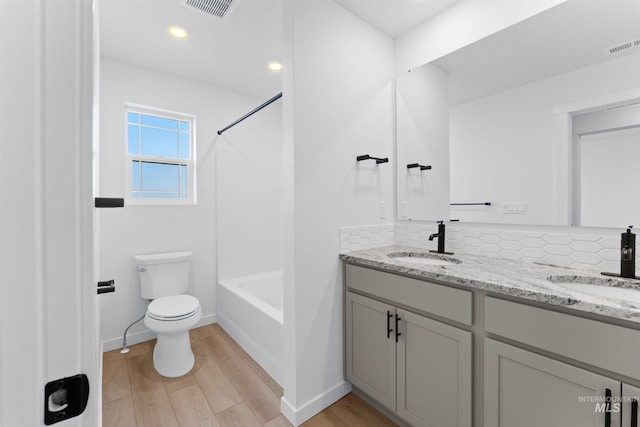 690 N Tessa Ave, Meridian, ID 83642 - bathroom featuring wood finished floors, toilet, double vanity, and baseboards