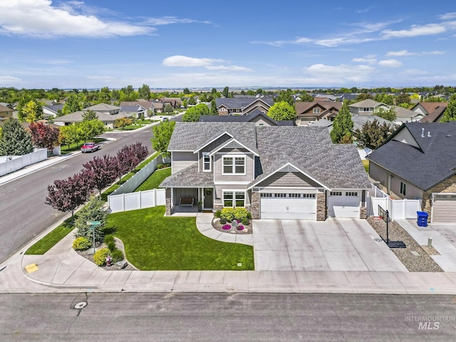 2858 Sunray Loop, Twin Falls, ID 83301 - view of front of home with a residential view, an attached garage, stone siding, and driveway