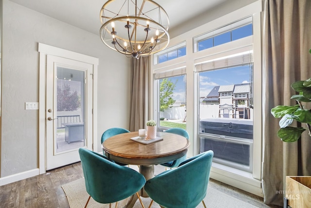 2858 Sunray Loop, Twin Falls, ID 83301 - dining room with a chandelier, wood finished floors, and baseboards