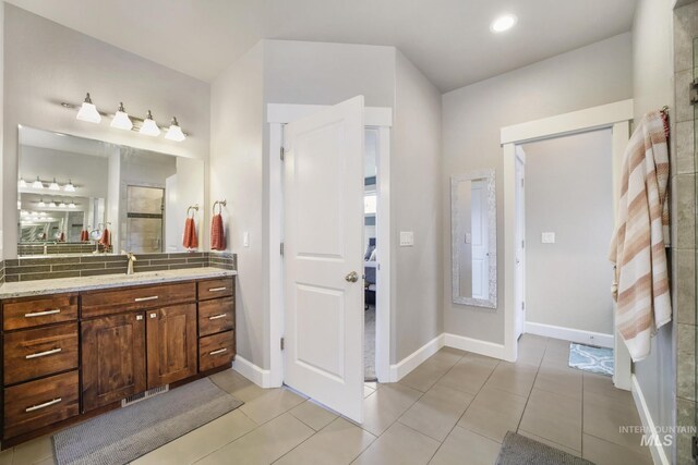 2858 Sunray Loop, Twin Falls, ID 83301 - full bathroom with vanity, tile patterned flooring, connected bathroom, and baseboards