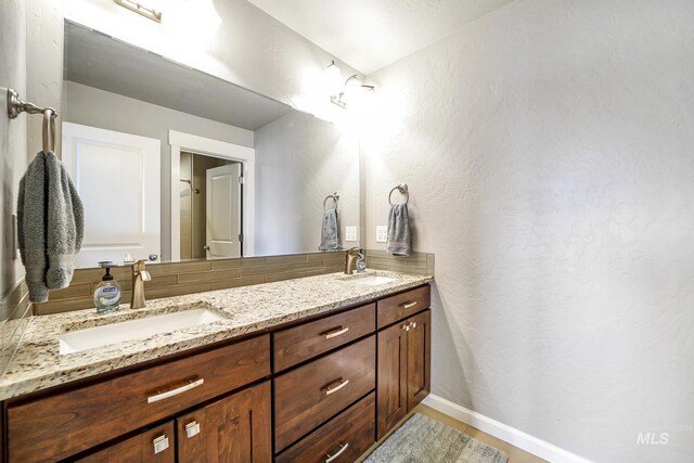 2858 Sunray Loop, Twin Falls, ID 83301 - bathroom with double vanity, baseboards, and a textured wall