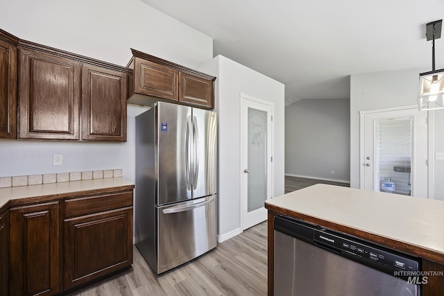 1030 Caswell Ave W, Twin Falls, ID 83301 - kitchen with appliances with stainless steel finishes, dark brown cabinetry, light wood-style flooring, light countertops, and decorative light fixtures