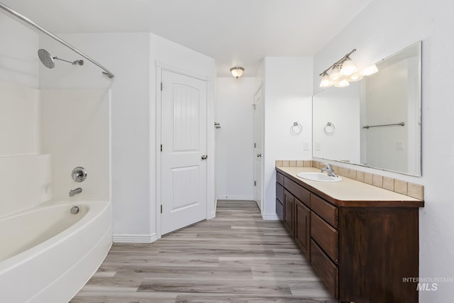 1030 Caswell Ave W, Twin Falls, ID 83301 - bathroom featuring vanity, wood finished floors, and shower / washtub combination