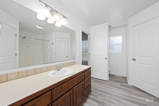 1030 Caswell Ave W, Twin Falls, ID 83301 - bathroom featuring vanity, wood finished floors, and a shower
