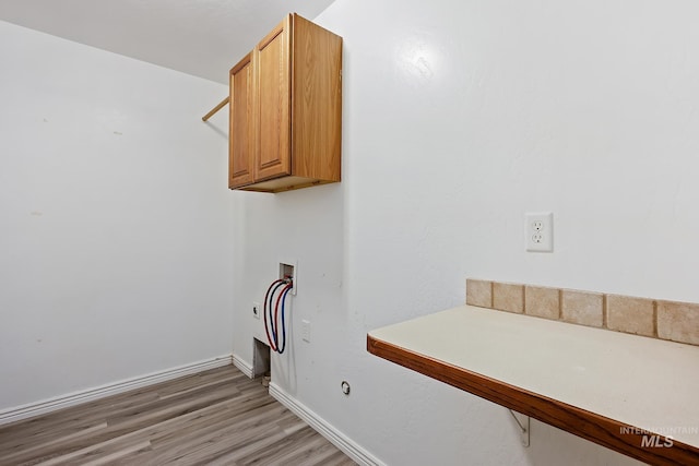1030 Caswell Ave W, Twin Falls, ID 83301 - washroom featuring washer hookup, cabinet space, and light wood finished floors