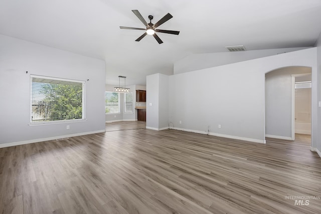 1030 Caswell Ave W, Twin Falls, ID 83301 - unfurnished living room with arched walkways, a ceiling fan, lofted ceiling, and light wood finished floors