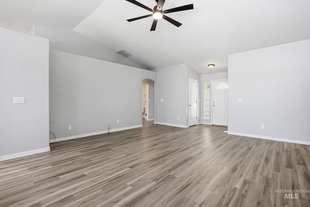 1030 Caswell Ave W, Twin Falls, ID 83301 - unfurnished living room featuring ceiling fan, arched walkways, wood finished floors, and lofted ceiling