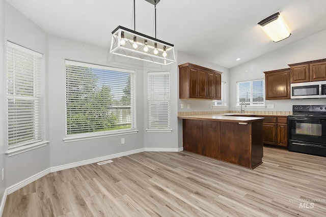 1030 Caswell Ave W, Twin Falls, ID 83301 - kitchen featuring stainless steel microwave, electric range, light wood-style floors, light countertops, and lofted ceiling
