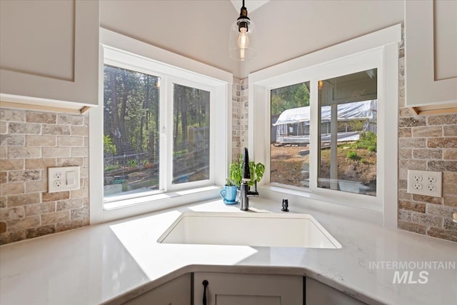 kitchen view of a sink and pendant lighting