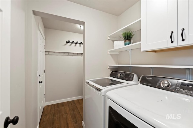 laundry area with cabinet space, washer and dryer, dark wood-style flooring, and baseboards
