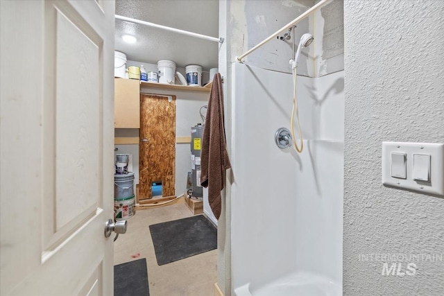 bathroom with a shower stall and water heater