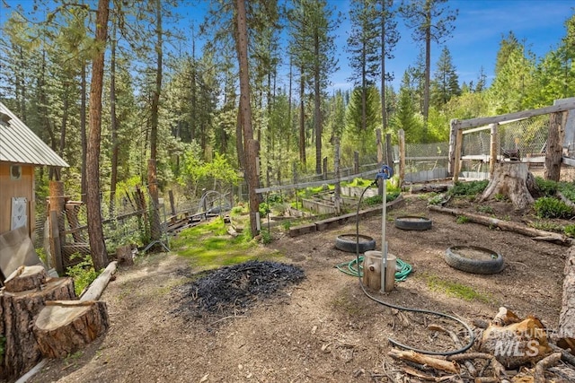 view of yard with a garden and fence