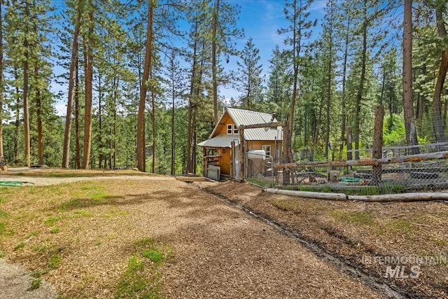 surrounding community with fence and an outdoor structure