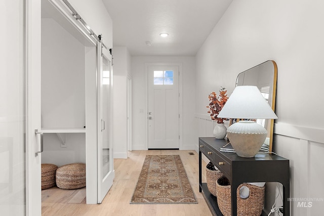 entrance foyer featuring a barn door and light hardwood / wood-style floors