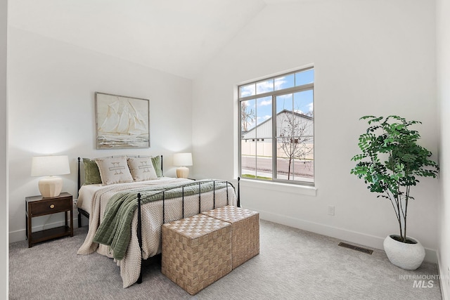 carpeted bedroom featuring high vaulted ceiling