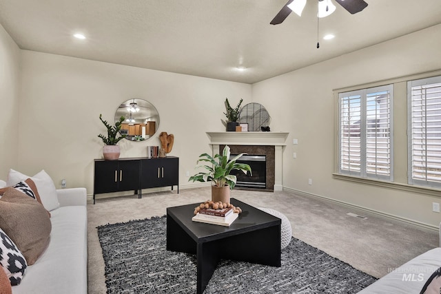 living room with baseboards, carpet floors, recessed lighting, a fireplace, and a ceiling fan