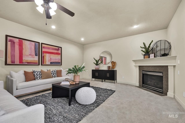 living area featuring carpet, a ceiling fan, baseboards, recessed lighting, and a high end fireplace