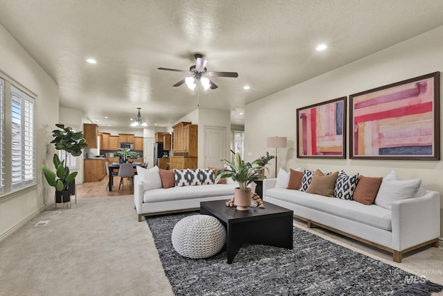 living area with visible vents, light carpet, recessed lighting, a textured ceiling, and a ceiling fan