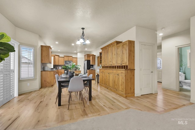 dining room featuring a chandelier, recessed lighting, and light wood-style flooring