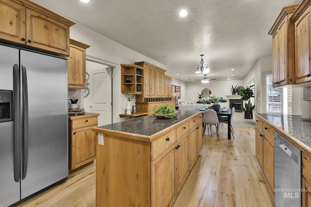 kitchen featuring a center island, light wood-style flooring, stainless steel appliances, and open shelves