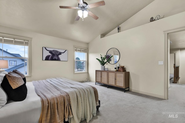 carpeted bedroom with vaulted ceiling, a ceiling fan, and baseboards