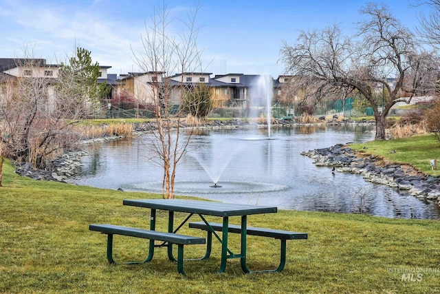 surrounding community featuring a yard and a water view