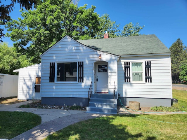 205 Nebraska, Gooding, ID 83330 - bungalow-style home with a front lawn, a chimney, and roof with shingles