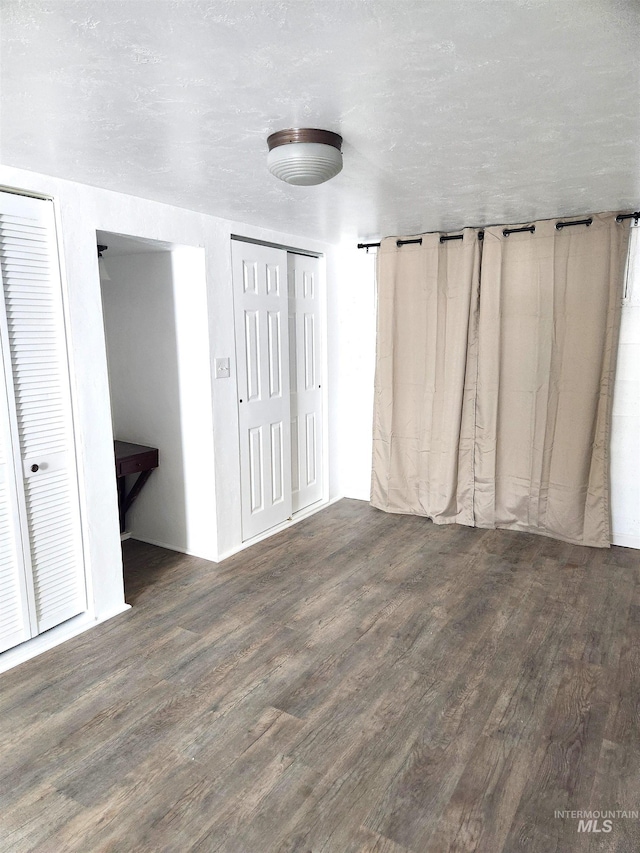 205 Nebraska, Gooding, ID 83330 - unfurnished bedroom with wood finished floors and multiple closets