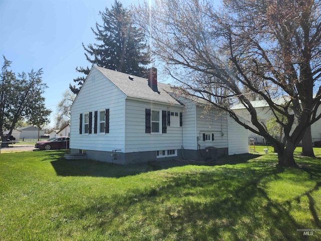 205 Nebraska, Gooding, ID 83330 - view of home's exterior featuring a chimney, a yard, and a shingled roof