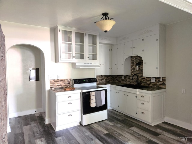 205 Nebraska, Gooding, ID 83330 - kitchen featuring electric range oven, exhaust hood, decorative backsplash, white cabinets, and dark wood-type flooring