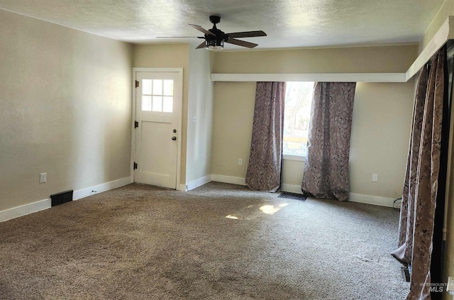 205 Nebraska, Gooding, ID 83330 - entryway featuring plenty of natural light, ceiling fan, carpet, and a textured ceiling