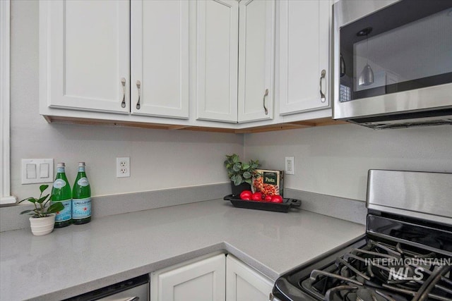 kitchen featuring stainless steel appliances and white cabinets