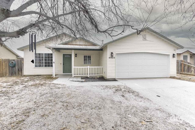 single story home featuring a garage and covered porch