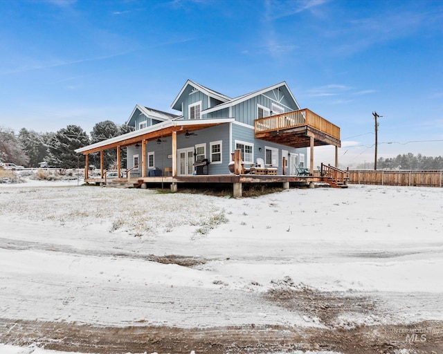 view of front of house with ceiling fan and a wooden deck