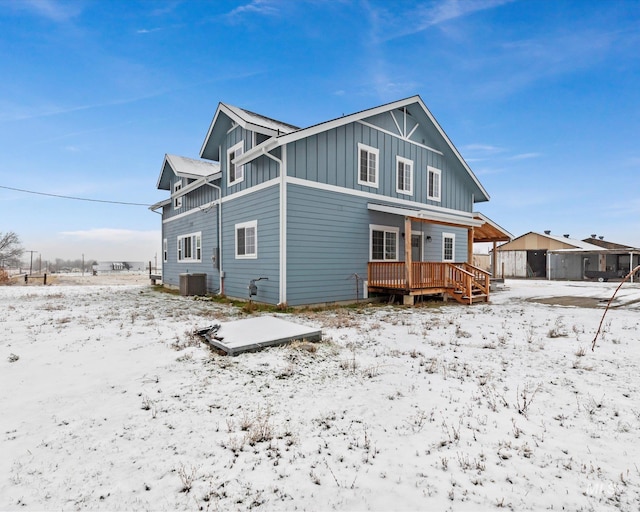 snow covered property featuring a deck and central AC unit